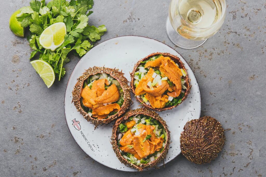 Fresh Santa Barbara sea urchin (uni) served in the shell with lime and white wine.